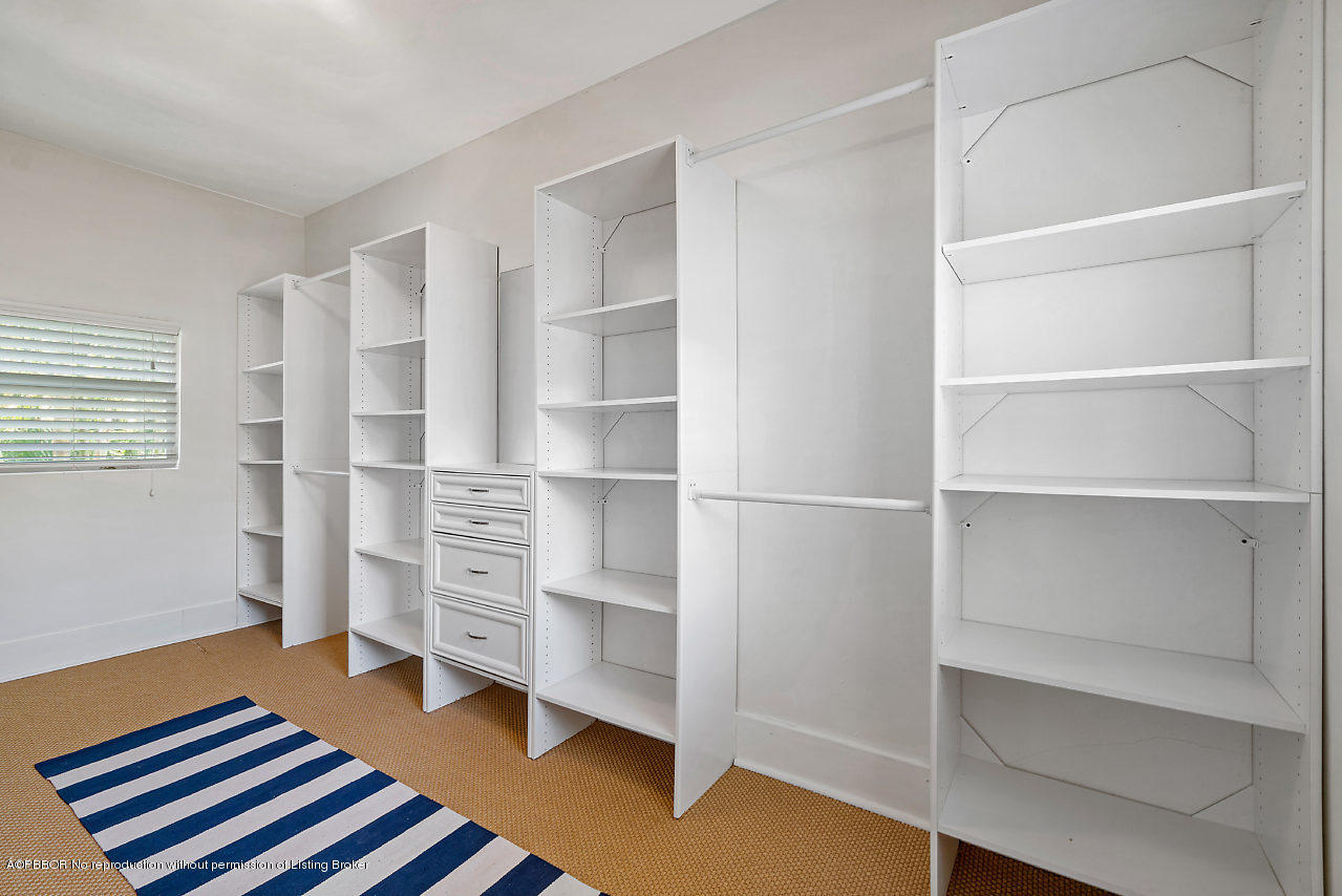 231 Dyer Road West Palm Beach, FL 33405 - Photo 25 of 45 a bedroom with a bed and a cabinet