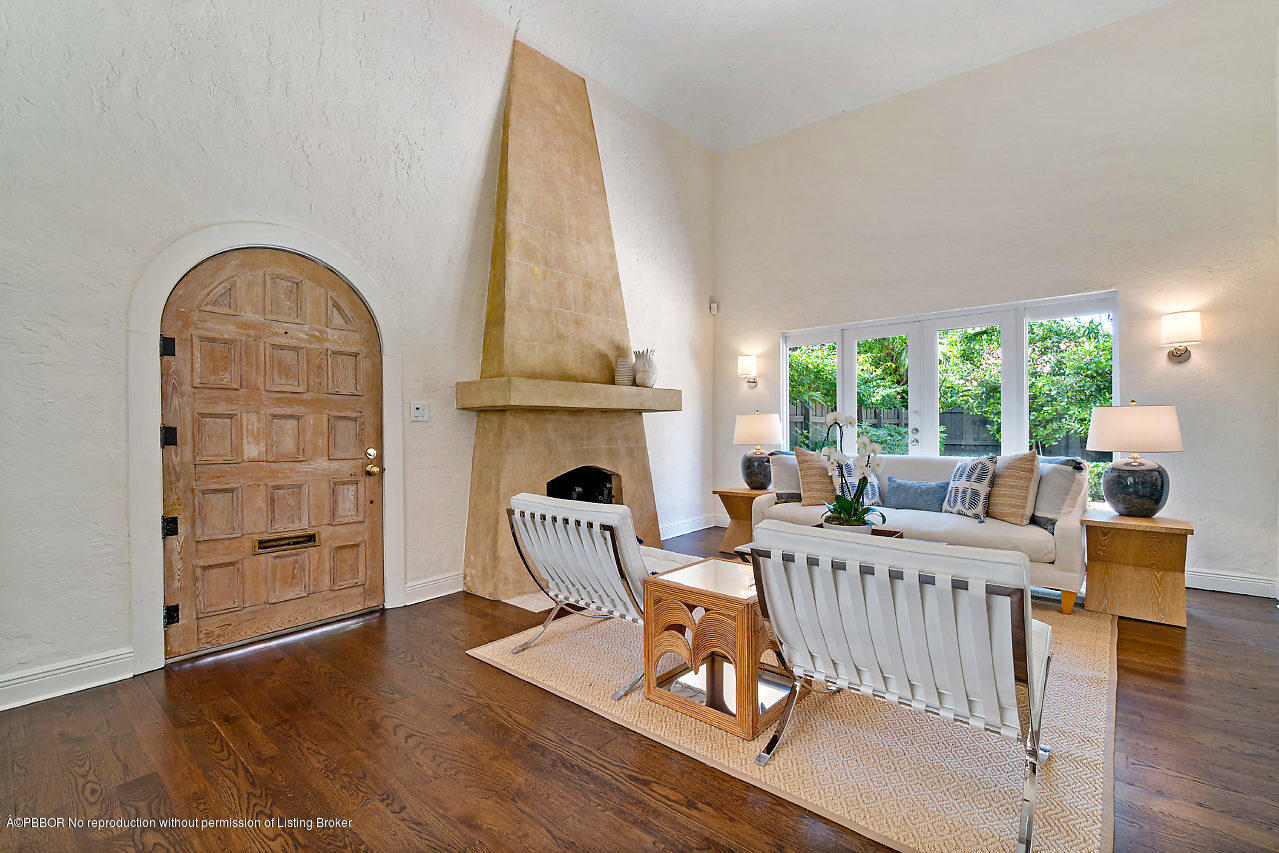 231 Dyer Road West Palm Beach, FL 33405 - Photo 4 of 45 a living room with furniture a fireplace and a floor to ceiling window