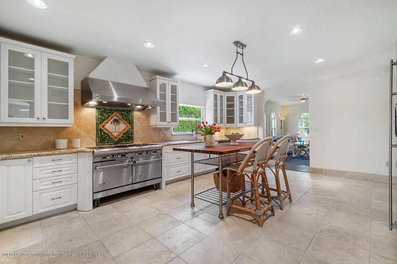 231 Dyer Road West Palm Beach, FL 33405 - Photo 7 of 45 a kitchen with stainless steel appliances a stove a table and chairs