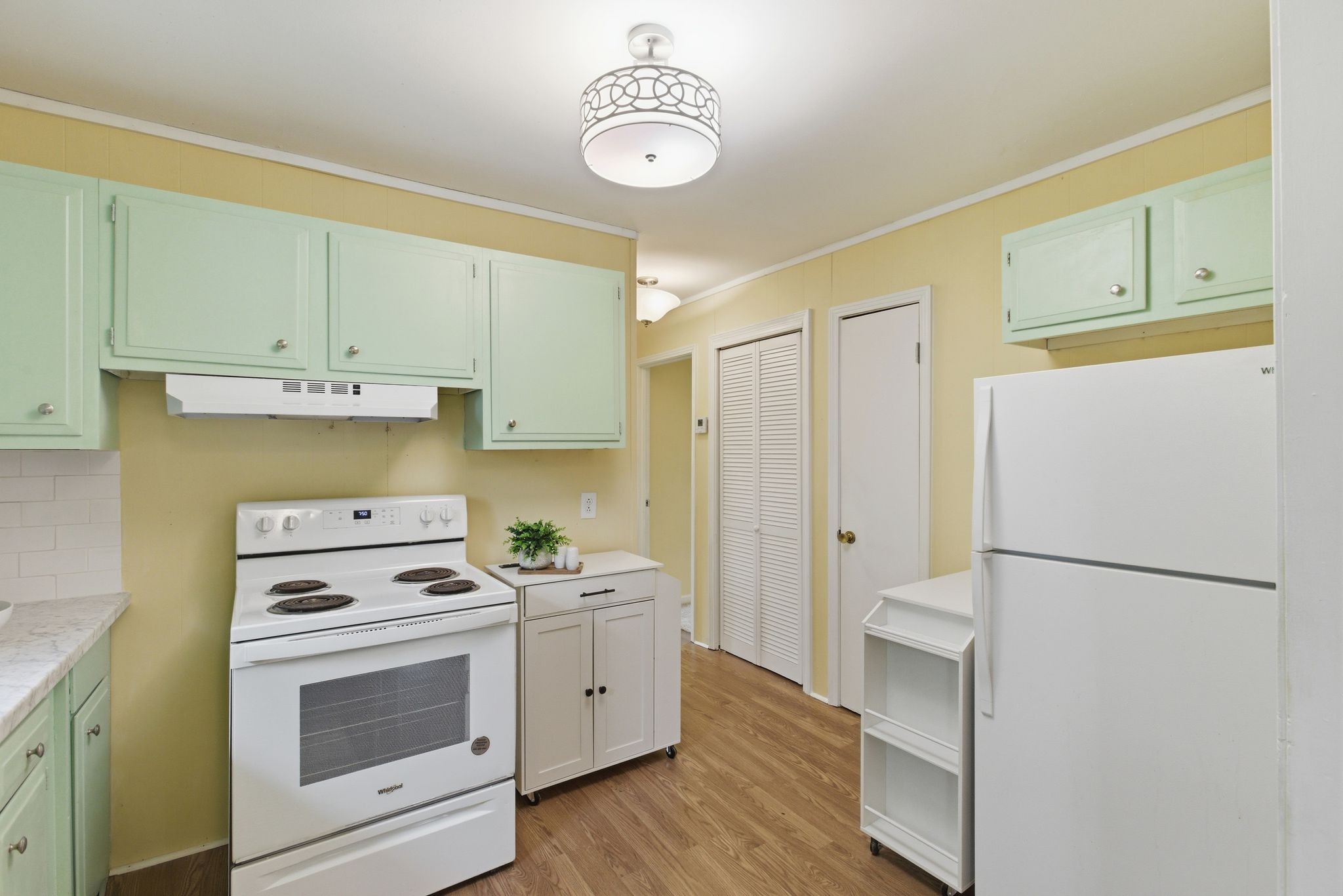 113 Mae Circle Dickson, TN 37055 - Photo 21 of 30 a kitchen with a refrigerator a stove cabinets and wooden floor