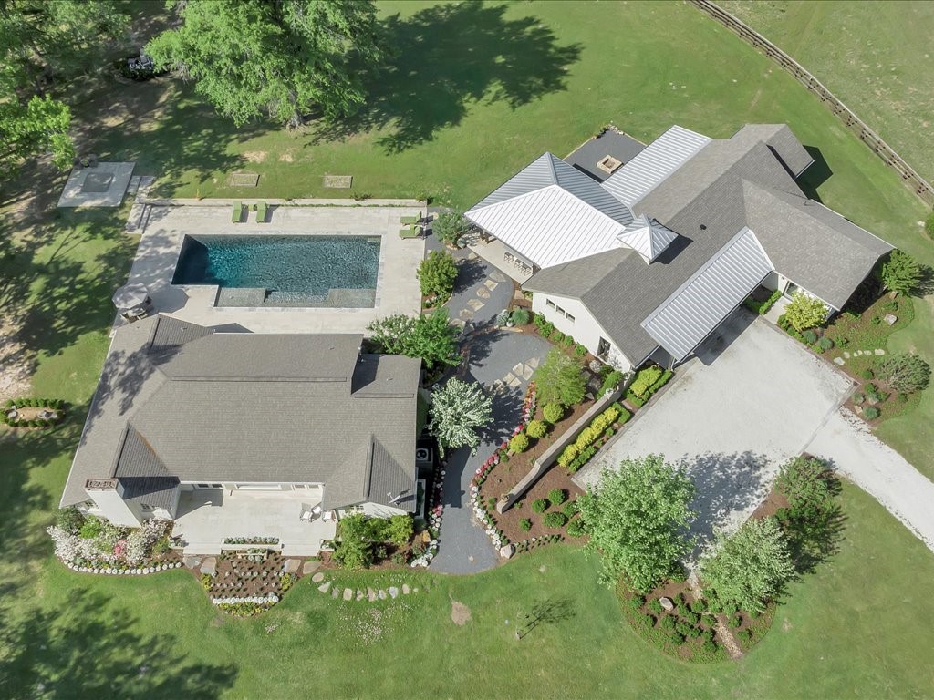 an aerial view of a house with yard swimming pool and outdoor seating