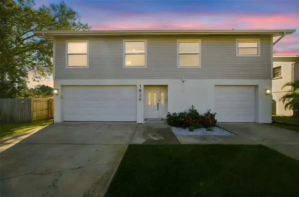 a front view of house and yard with green space