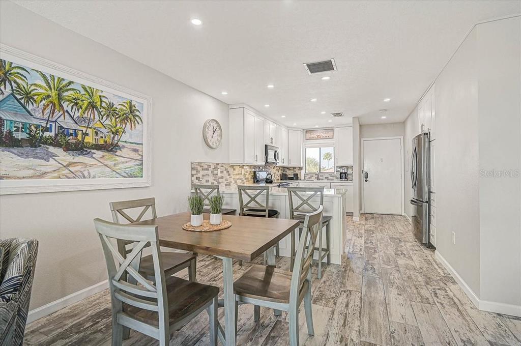 1624 Stickney Point Road, Unit 1624301 Sarasota, FL 34231 - Photo 12 of 55 a view of a dining room with furniture and wooden floor
