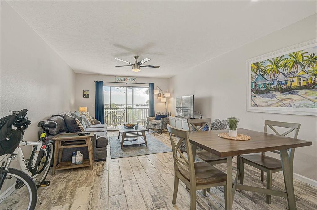 1624 Stickney Point Road, Unit 1624301 Sarasota, FL 34231 - Photo 13 of 55 a living room with furniture and wooden floor