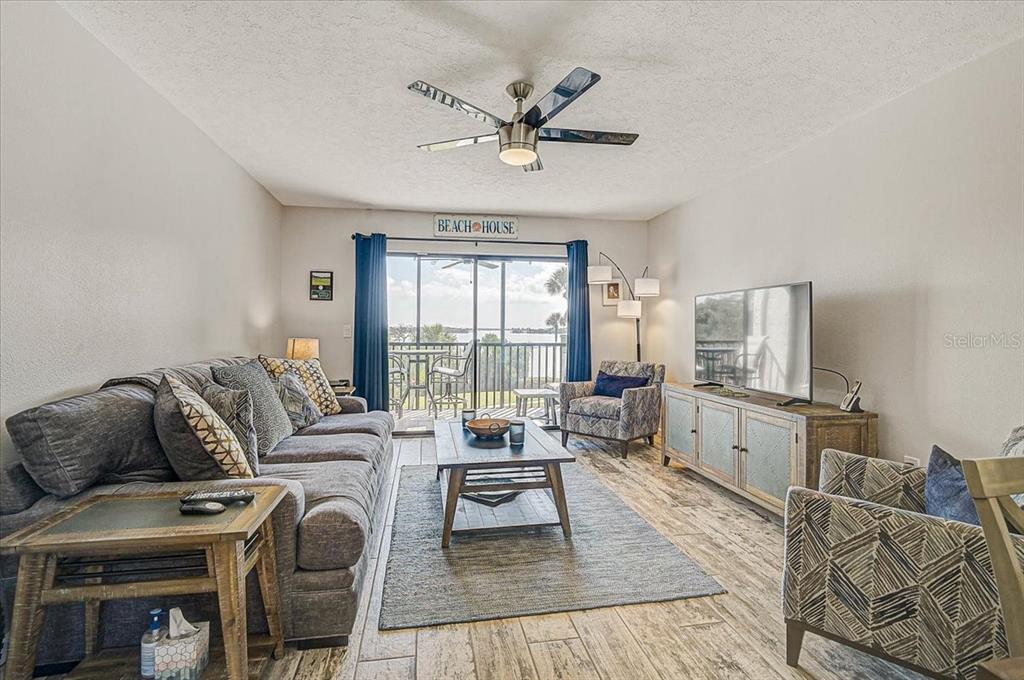 1624 Stickney Point Road, Unit 1624301 Sarasota, FL 34231 - Photo 14 of 55 a living room with furniture and a large window