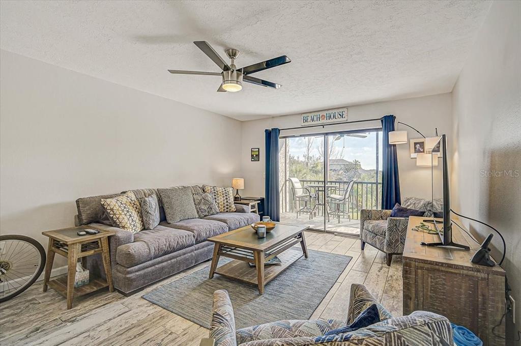 1624 Stickney Point Road, Unit 1624301 Sarasota, FL 34231 - Photo 15 of 55 a living room with furniture and a window