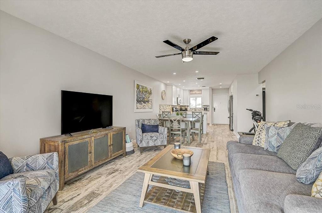 1624 Stickney Point Road, Unit 1624301 Sarasota, FL 34231 - Photo 16 of 55 a living room with furniture and a flat screen tv