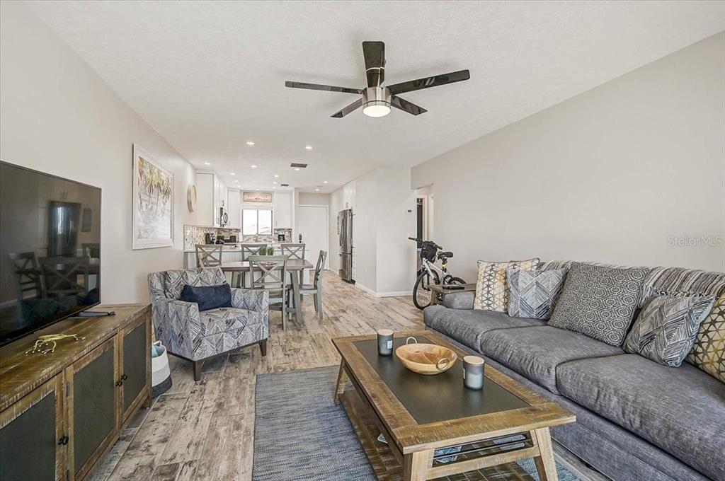 1624 Stickney Point Road, Unit 1624301 Sarasota, FL 34231 - Photo 17 of 55 a living room with furniture and a flat screen tv