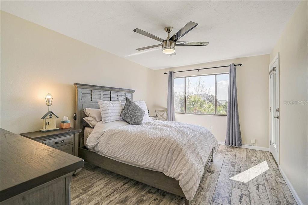 1624 Stickney Point Road, Unit 1624301 Sarasota, FL 34231 - Photo 18 of 55 a bedroom with a bed and a window
