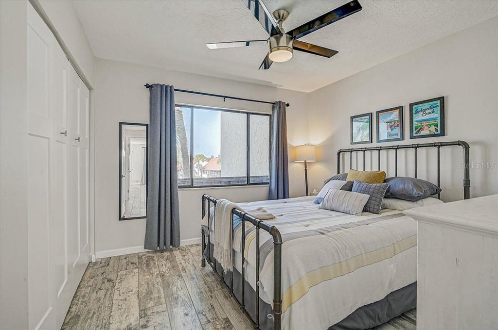 1624 Stickney Point Road, Unit 1624301 Sarasota, FL 34231 - Photo 22 of 55 a bedroom with a bed and a window