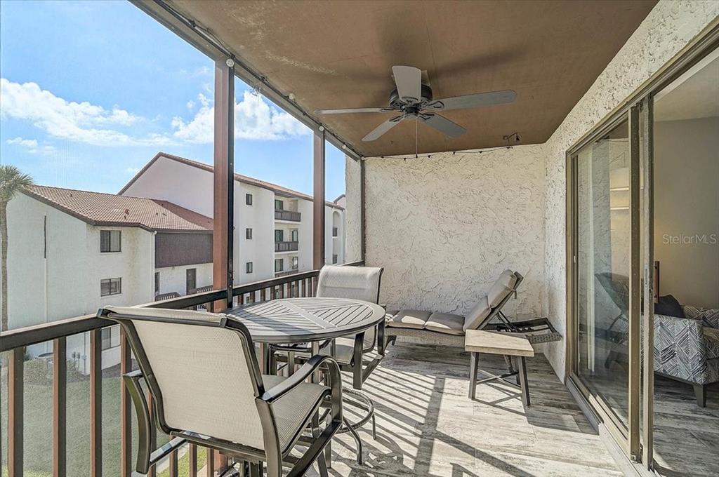 1624 Stickney Point Road, Unit 1624301 Sarasota, FL 34231 - Photo 25 of 55 a view of a patio with a dining table and chairs