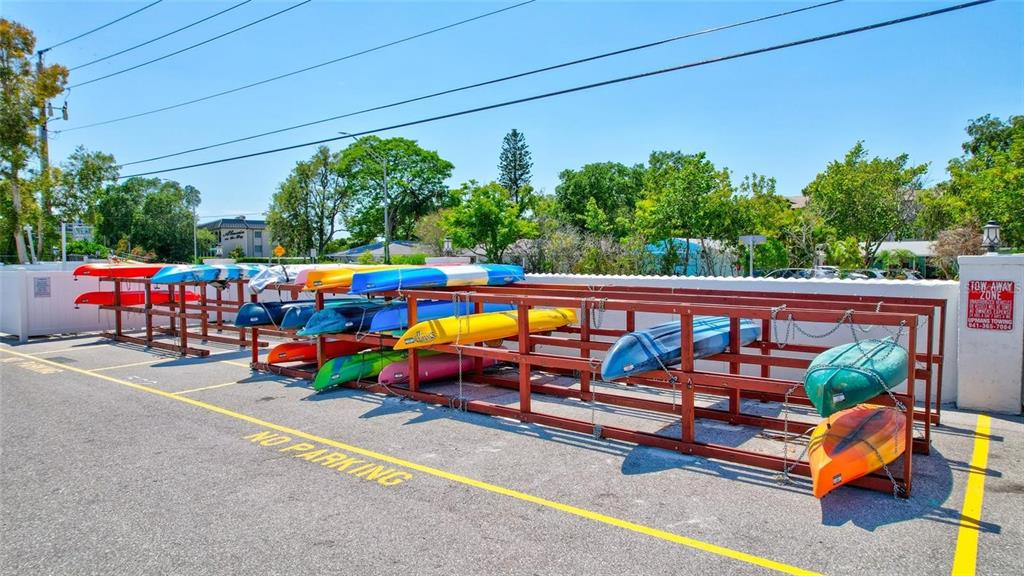 1624 Stickney Point Road, Unit 1624301 Sarasota, FL 34231 - Photo 40 of 55 a view of swimming pool with red chairs in front of it