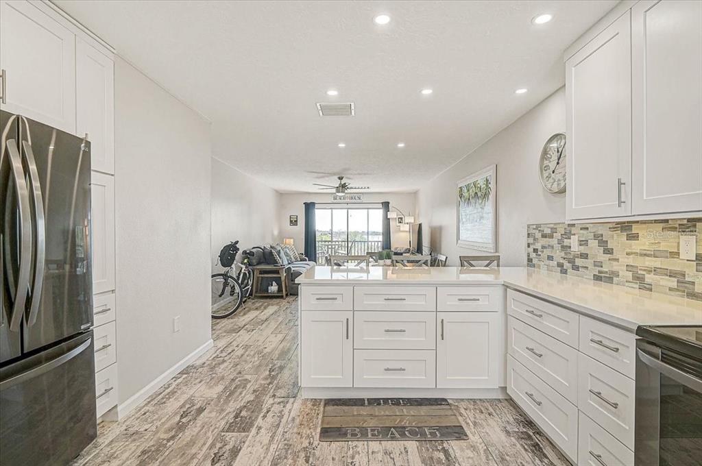 1624 Stickney Point Road, Unit 1624301 Sarasota, FL 34231 - Photo 8 of 55 a kitchen with granite countertop cabinets and stainless steel appliances