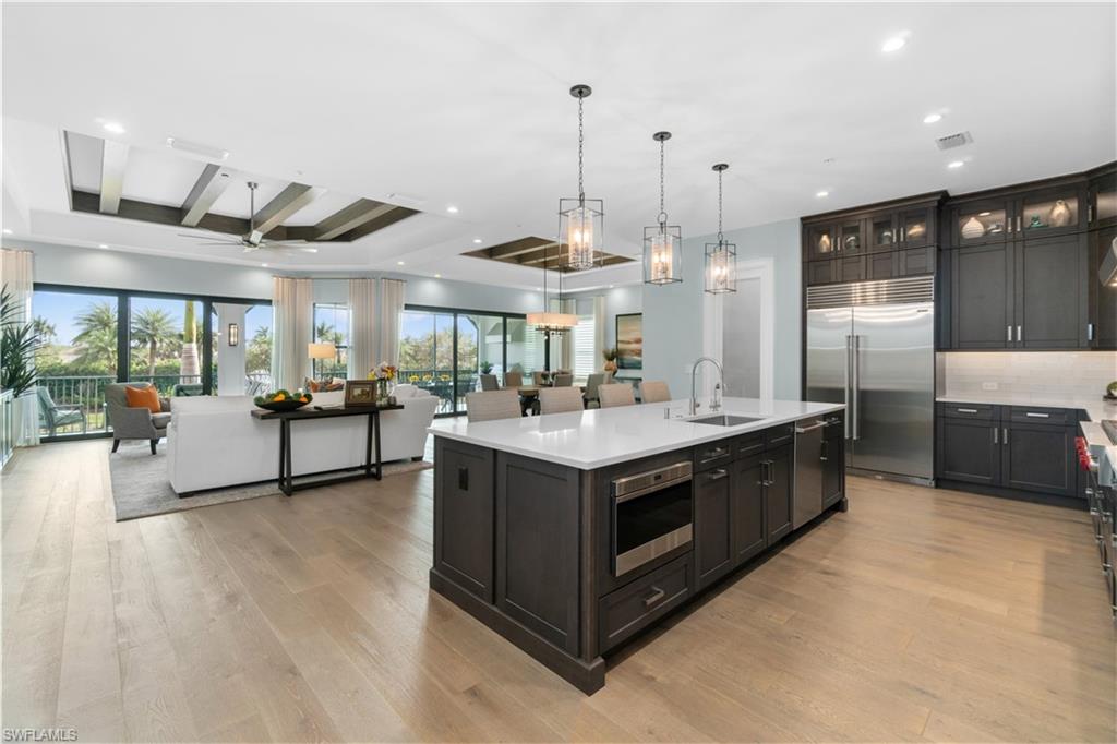 a kitchen with stainless steel appliances granite countertop a stove and a large window