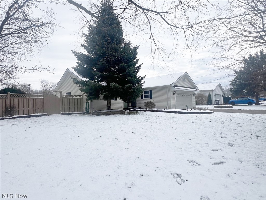 5203 Ridgeland Street Lorain, OH 44055 - Photo 3 of 39 Yard layered in snow featuring a garage