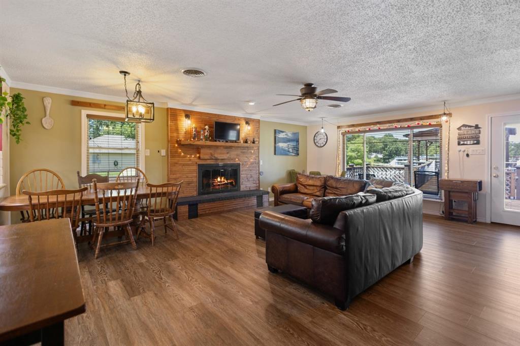 227 Scenic Road Trinidad, TX 75163 - Photo 11 of 40 a living room with furniture ceiling fan and a fireplace