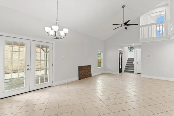 a view of a livingroom with a chandelier furniture and windows