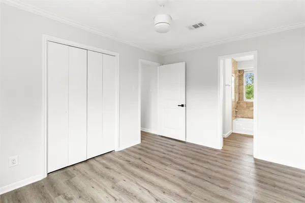 a view of an empty room with wooden floor