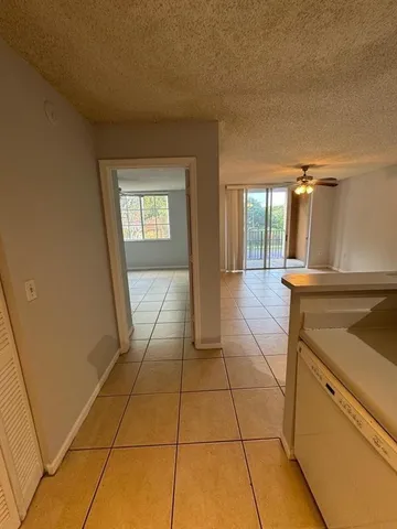 a empty room with windows and fan