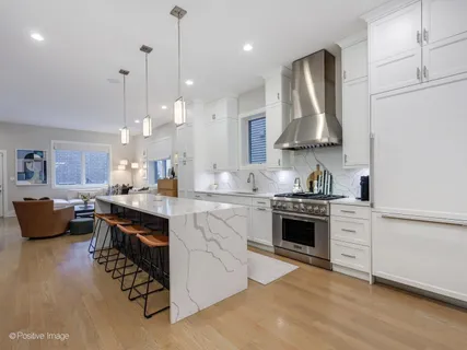 a kitchen with stainless steel appliances granite countertop a stove sink and refrigerator