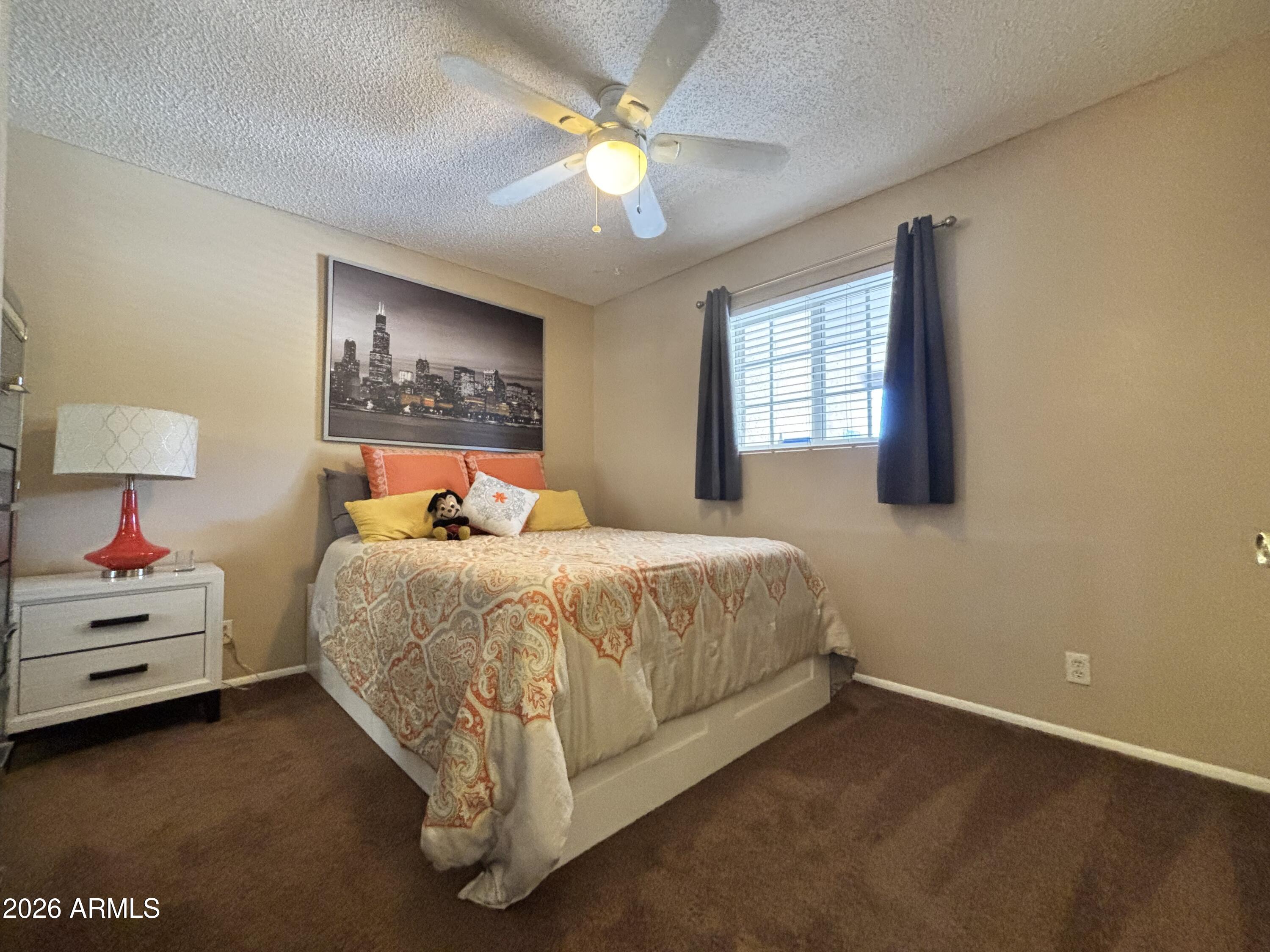 7745 East Mangun Road Mesa, AZ 85207 - Photo 29 of 35 a spacious bedroom with a bed and a chandelier
