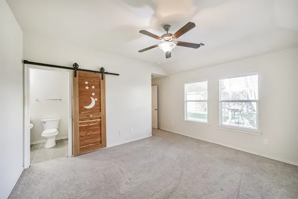 a bathroom with a shower and toilet