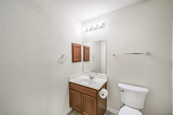 an empty room with windows and ceiling fan