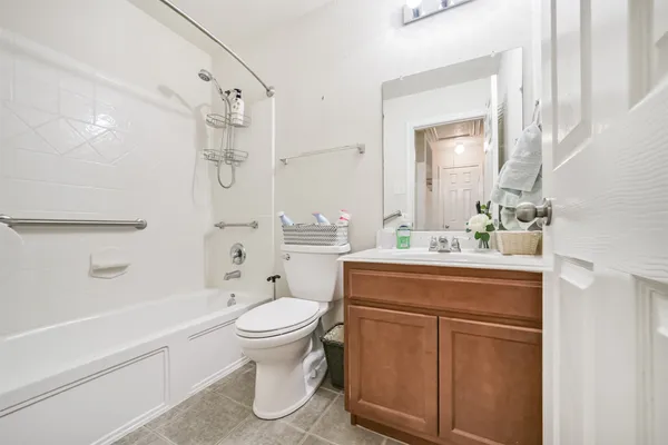 an empty room with window and ceiling fan