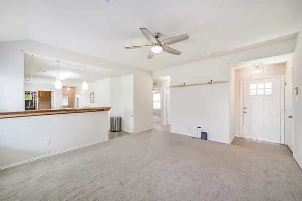 a large kitchen with cabinets stainless steel appliances and a counter space