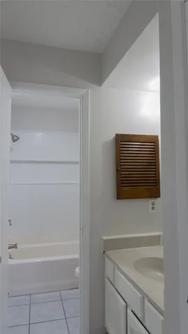 a view of a backyard with plants and large tree