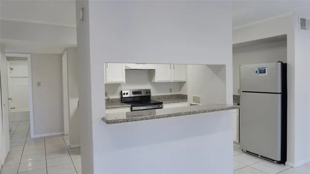 a kitchen with a refrigerator a stove and a sink