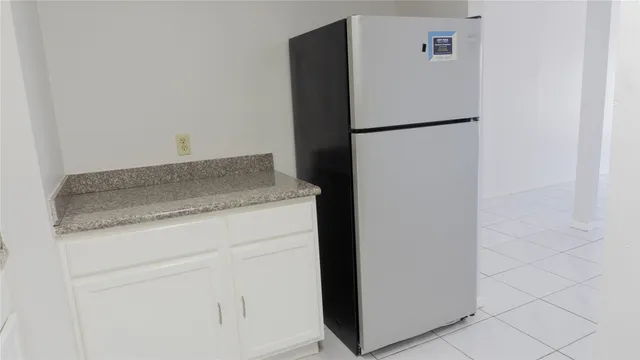 a white refrigerator freezer sitting inside of a kitchen