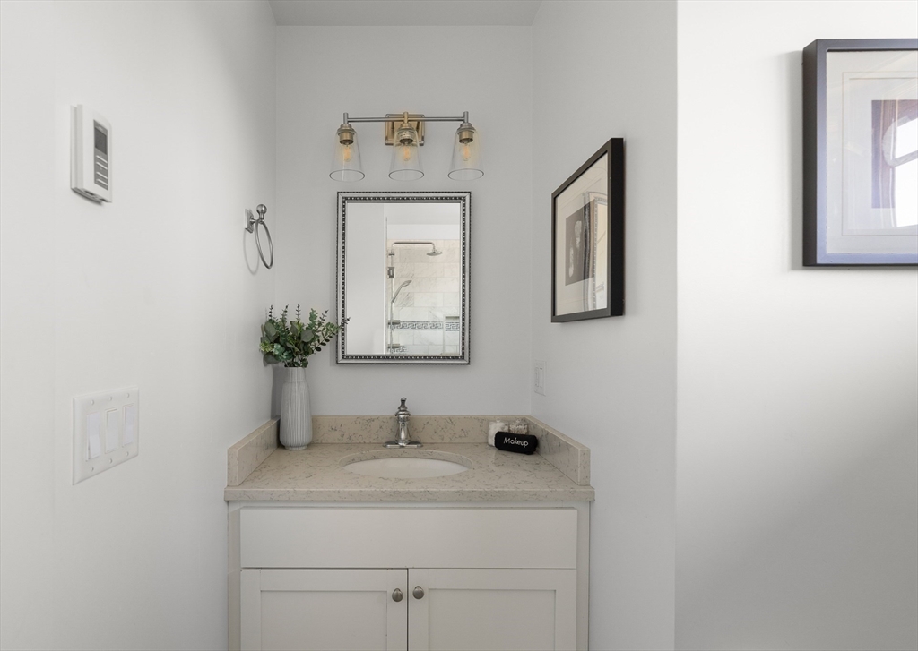 13 Young Street Edgartown, MA 02539 - Photo 15 of 29 a bathroom with a sink and a mirror