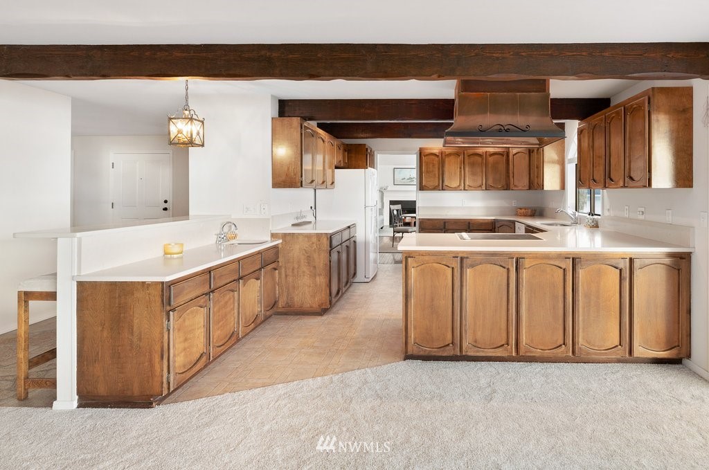 3082 Mount Baker Circle Oak Harbor, WA 98277 - Photo 21 of 40 a kitchen with stainless steel appliances granite countertop a stove a sink and a refrigerator