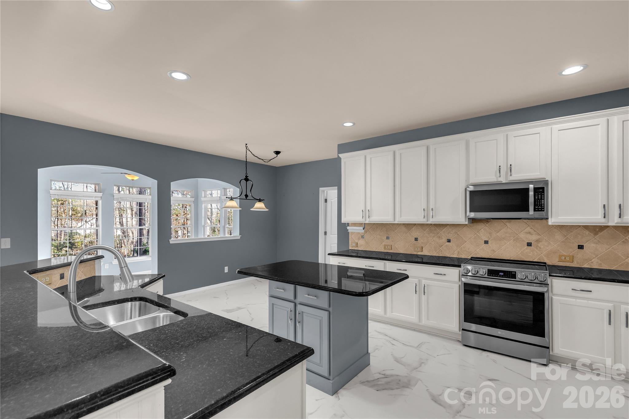 1644 Spandril Lane Fort Mill, SC 29708 - Photo 11 of 32 a kitchen with stainless steel appliances granite countertop a stove a sink and a microwave