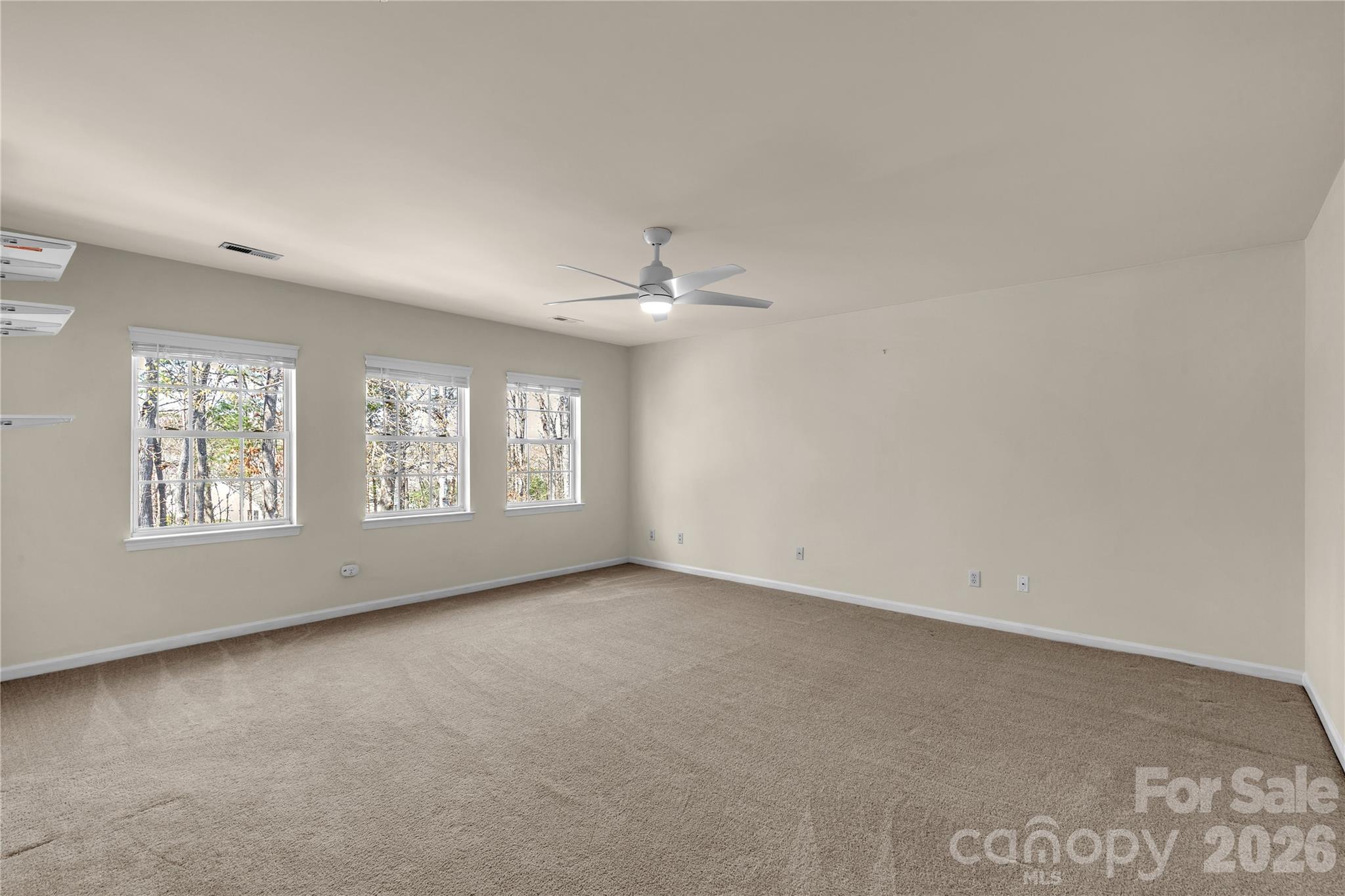 1644 Spandril Lane Fort Mill, SC 29708 - Photo 18 of 32 an empty room with windows and ceiling fan