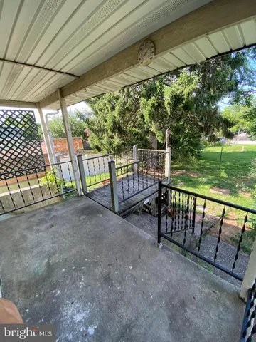 a view of porch with furniture and garden