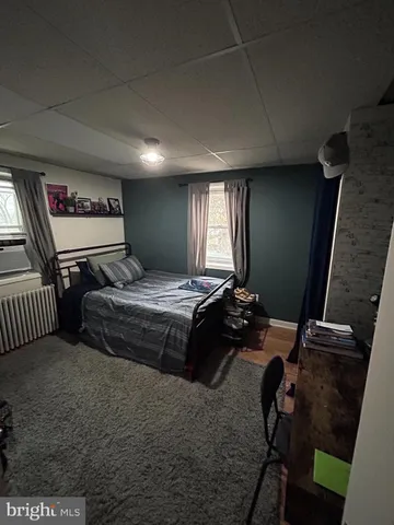 a bedroom with bed and window