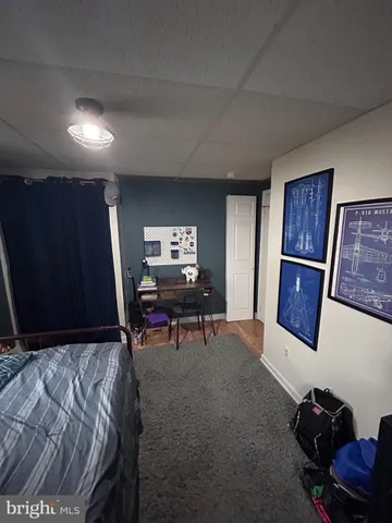 a bed room with a bed and a television