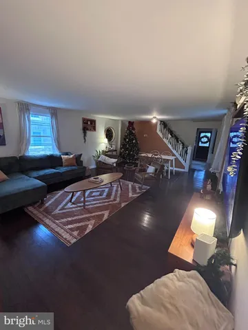 a living room with furniture and a lamp