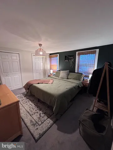 a bedroom with a bed and dresser