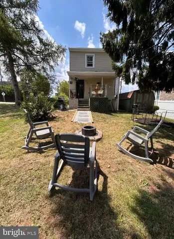 a view of a house with backyard porch and sitting area
