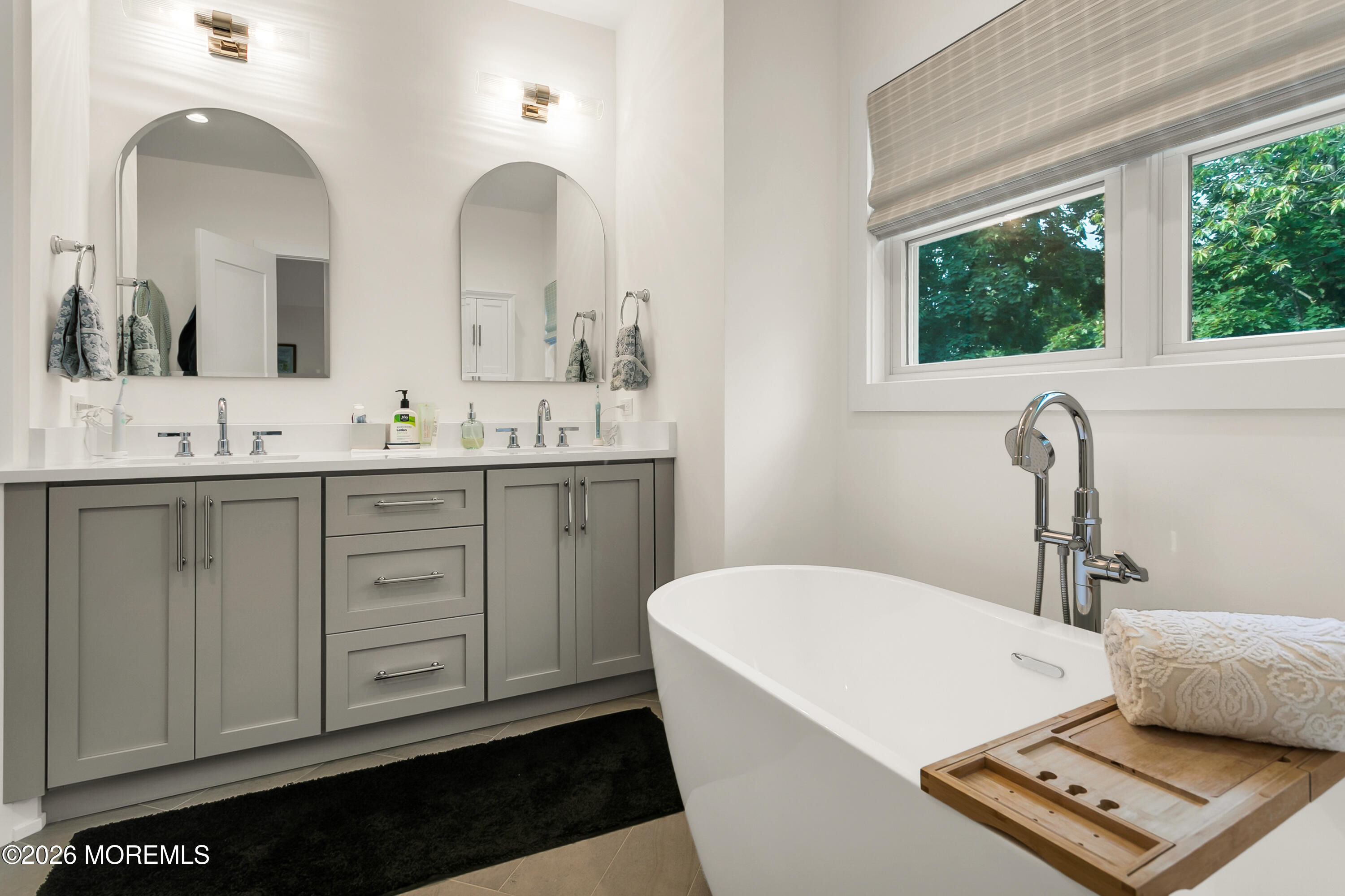61 Center Street Rumson, NJ 07760 - Photo 15 of 30 a bathroom with a sink a window and mirror