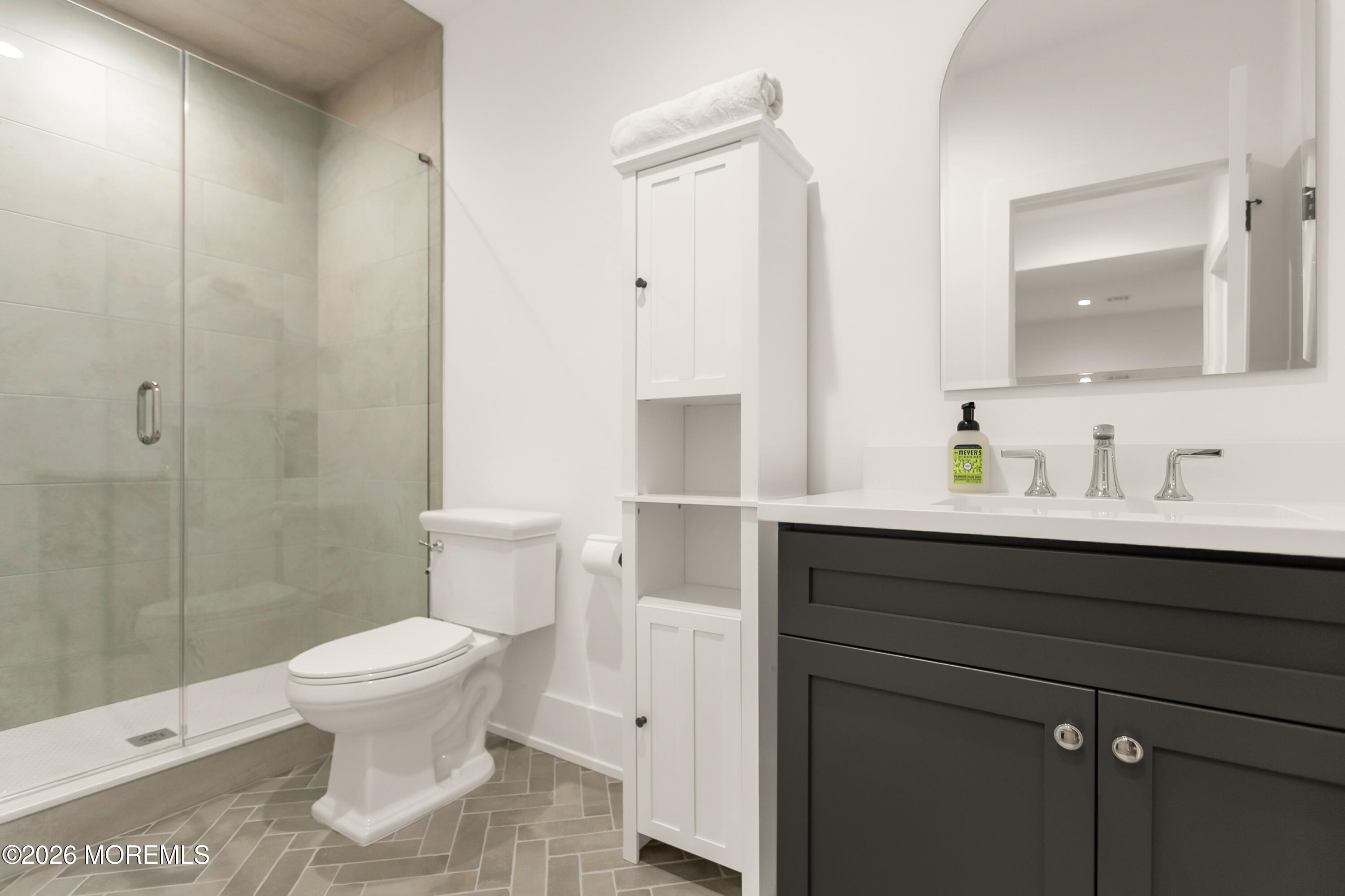 61 Center Street Rumson, NJ 07760 - Photo 27 of 30 a bathroom with a sink a toilet and shower