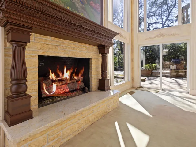 a living room with fireplace furniture and a flat screen tv