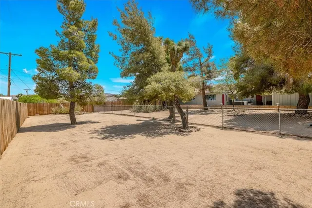a front view of a house with a tree