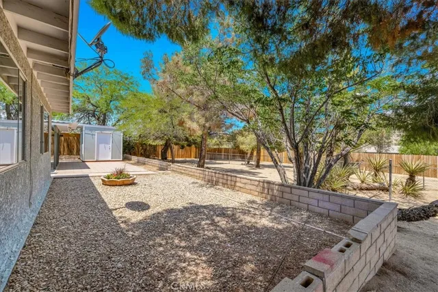 a view of a porch with a table and chairs and potted plants