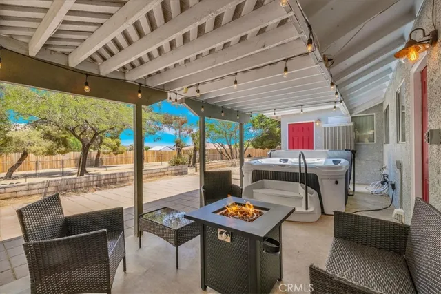 a view of a backyard with chairs and plants