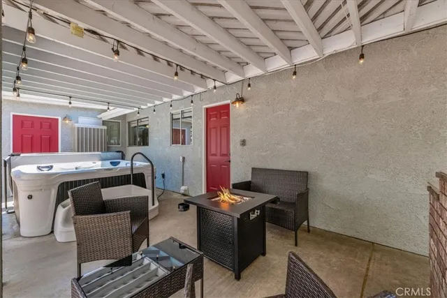 a view of a patio with a table and chairs and floor to ceiling window