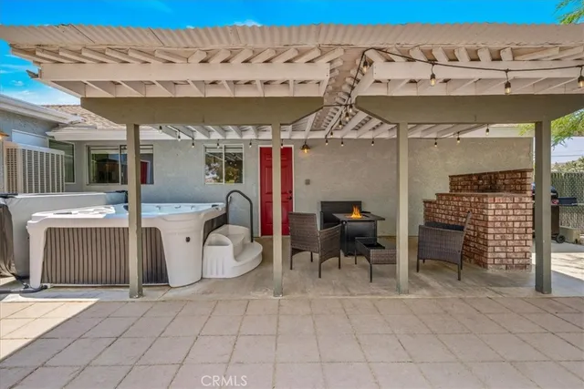 a living room with furniture large window and flat screen tv